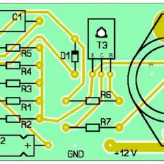 Schemat elektroniczny z elementami: T1, T2, T3, T4, R1-R7, C1, C2, D1, LAMP. Widoczne oznaczenia GND i +12 V.